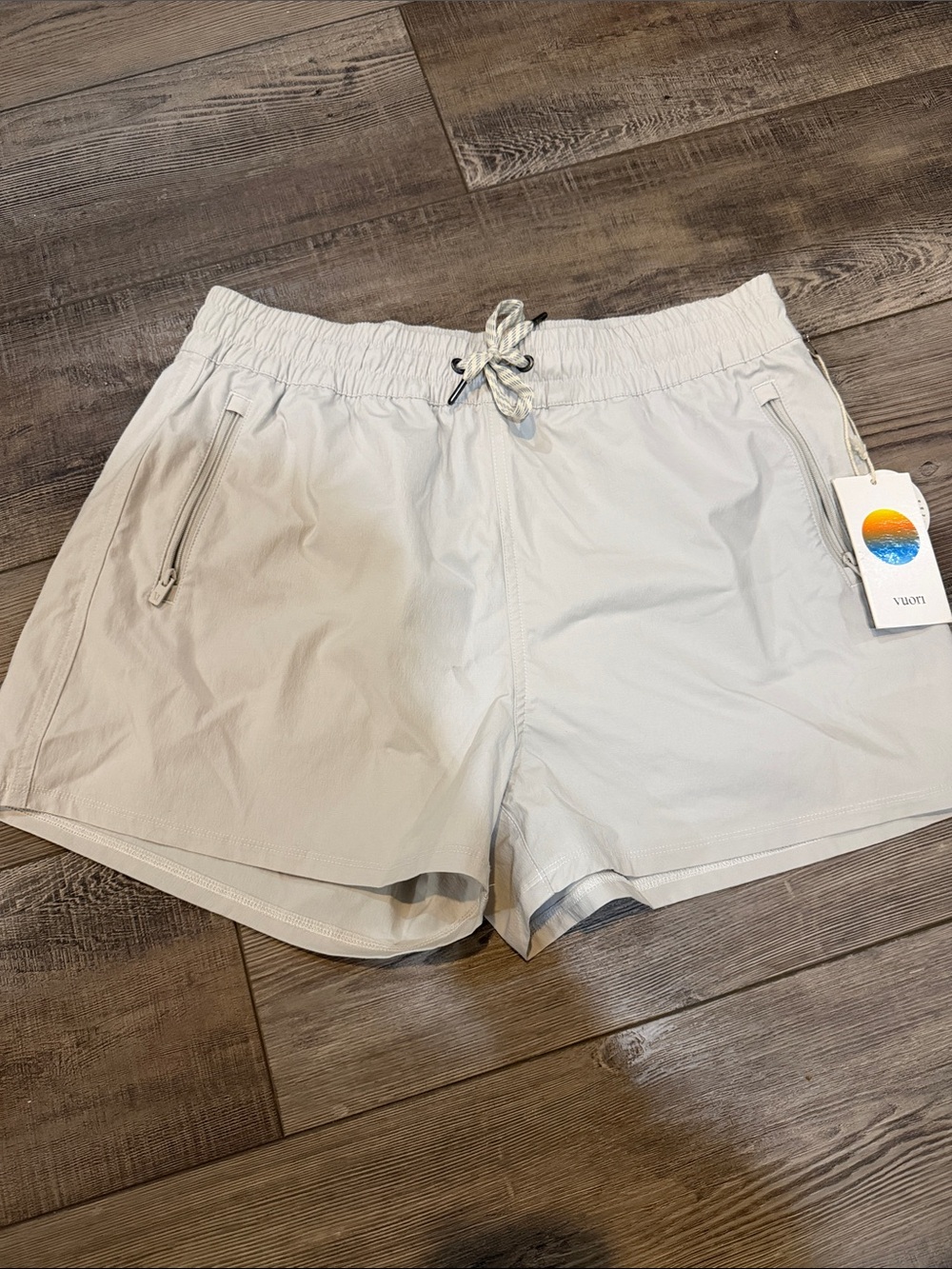 Vuori Women's Light Cream Athletic Shorts with Zipper Pockets